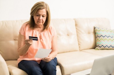 A Woman Looking At Her Credit Card Debt