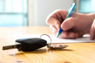 Man Signing A Car Loan