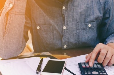 Man Using Calculator
