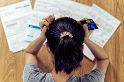 Stressed woman with lots of debt