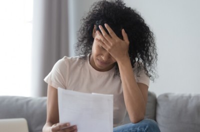 Stressed Woman Reading A Debt Letter