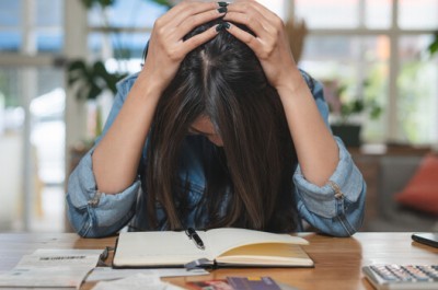 Stressed Woman With Lots Of Debt