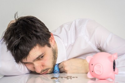 Worried Man With Empty Piggy Bank