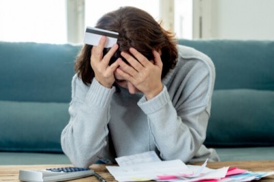 Worried Woman In Heaps Of Debt