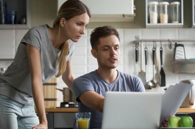 Young Couple On Laptop Seeking Advice