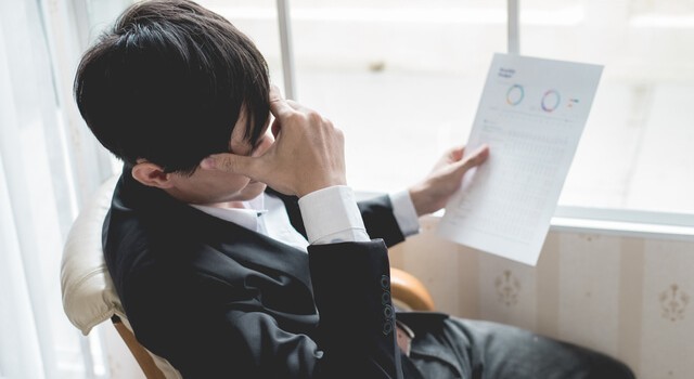 Businessman Holding A Credit Report