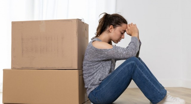 Sad woman with boxes