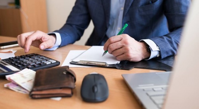 Business man paying a tax bill