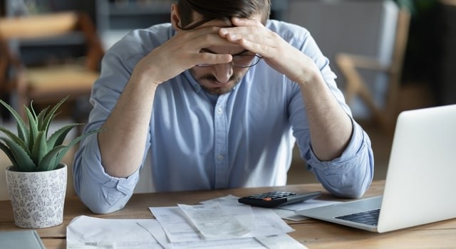 Man Deciding On His Debts