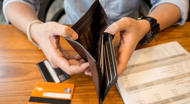 Man Holding An Empty Wallet With Credit Cards
