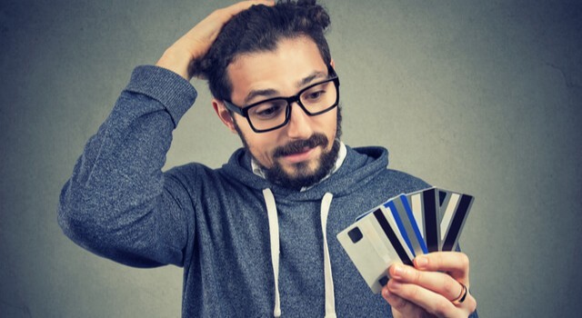 Man Holding Credit Cards