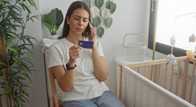 Woman on the phone holding a credit card