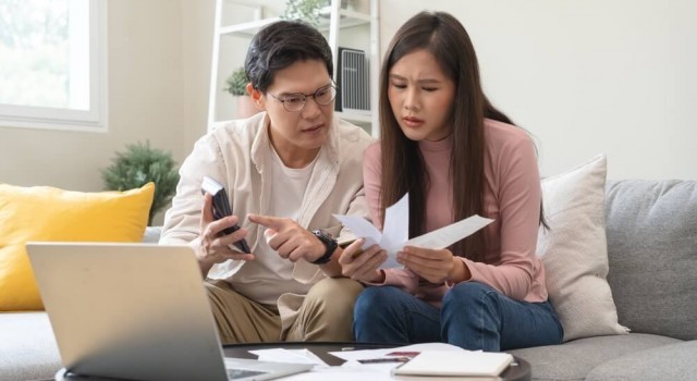 Asian couple with debts