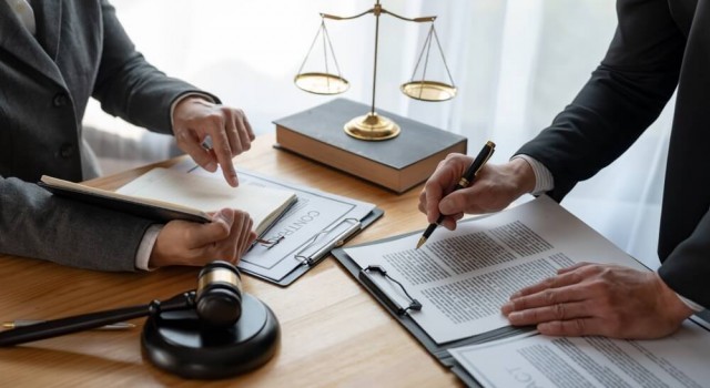 Lawyer, legal advisor, businessman brainstorming information on agreement details Business contracts in legal processing books for accuracy in contract documents. joint financial investment.