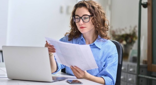 Busy woman working out tax bill