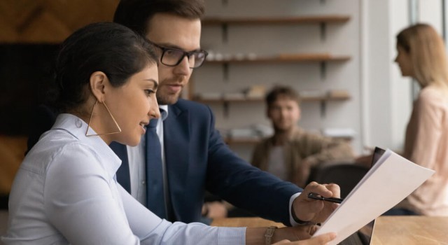 Two people looking at a document