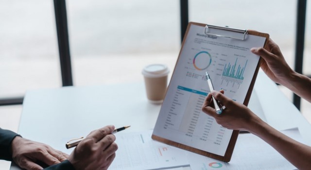 Two people looking at a balance sheet