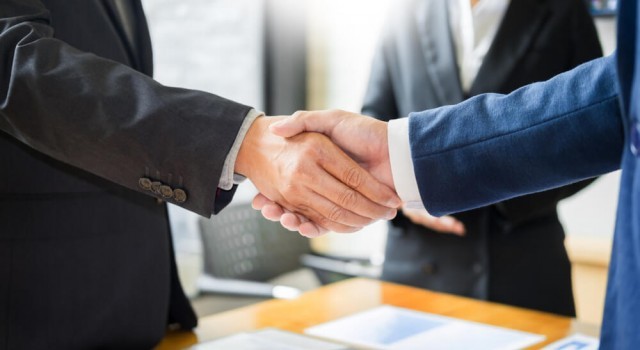 Two people shaking hands on an agreement